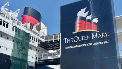 Workers do painting touch-ups on the Queen Mary.