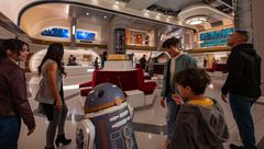 A droid greets guests at Star Wars: Galactic Starcruiser.