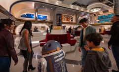 A droid greets guests at Star Wars: Galactic Starcruiser.