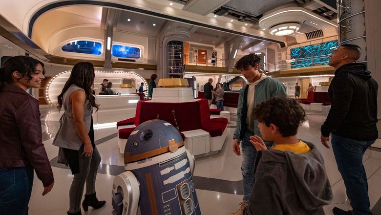A droid greets guests at Star Wars: Galactic Starcruiser.