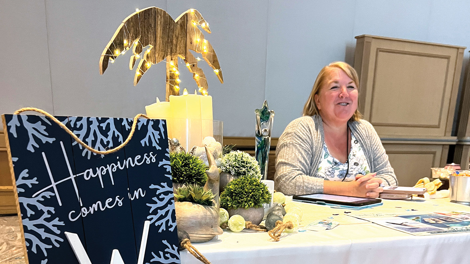 Tina Bradley of Wish You Were Here Vacations in Winter Haven, Fla., was a winner of GTM table design, she said (there was no official competition this year). Her sign says "happiness comes in waves" -- and yes, she sells cruises.