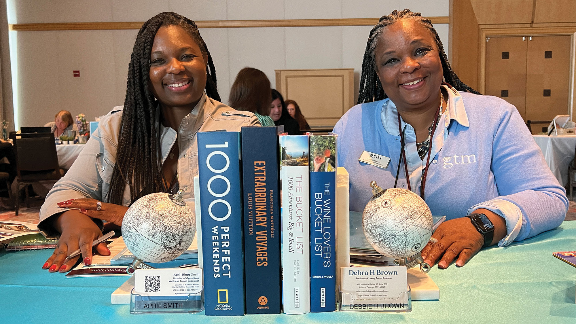 Globes and travel books are the epitome of travel-forward design, and April Smith, left, said her travel agency is full of books. She shared the table with Debra Brown, who was one of this year's GTM advisory board members (hence the official, GTM light blue cardigan).