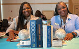 Globes and travel books are the epitome of travel-forward design, and April Smith, left, said her travel agency is full of books. She shared the table with Debra Brown, who was one of this year's GTM advisory board members (hence the official, GTM light blue cardigan).