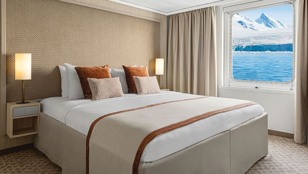 The bedroom in a redesigned Category 6 suite on National Geographic Explorer.