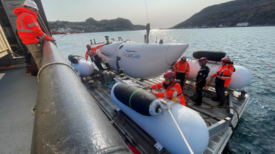 Before heading to the wreck site on May 20, 2023, the OceanGate crew secures the Titan sub and its launch and recovery platform in St. John’s, Newfoundland. OceanGate CEO Stockton Rush, now missing on the Titan submersible, is in the black scuba diving suit.