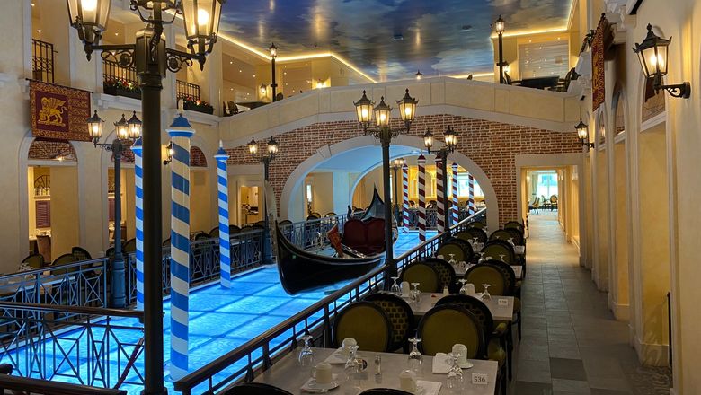 A gondola seemingly floats through the center of the Canal Grande Restaurant on the Carnival Venezia.