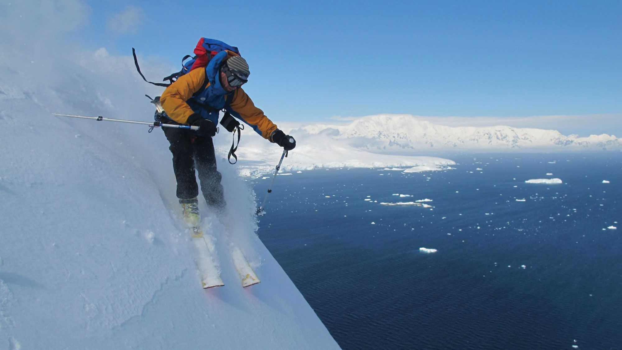A heli-skier races down a mountain in Antarctica on an extreme adventure tour with Pelorus.