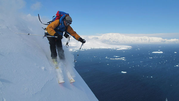 A heli-skier races down a mountain in Antarctica on an extreme adventure tour with Pelorus.