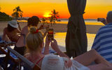 Poolside, visitors to Makokola Retreat watch the sunset.
