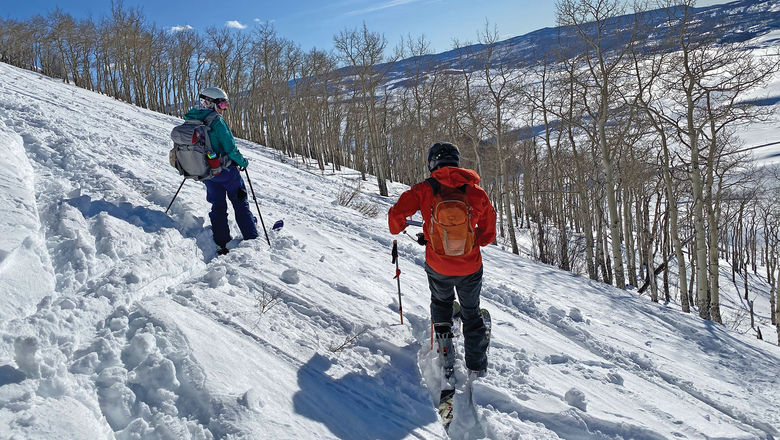 Uphill skiers preparing to drop in to a run at Bluebird Backcountry mountain in Colorado. Bluebird Backcountry, the trailblazing, lift-less ski area that was the first to offer backcountry skiing, but with ski patrol and avalanche management, has closed.