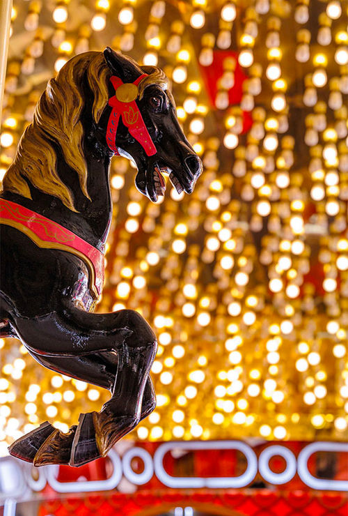 Merry-go-round horses move up and down, greeting visitors to the Carousel Bar at the Plaza Hotel & Casino.