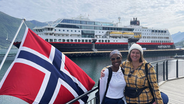 The writer, right, and her guest paused for a photo when the ship called in Andalsnes.