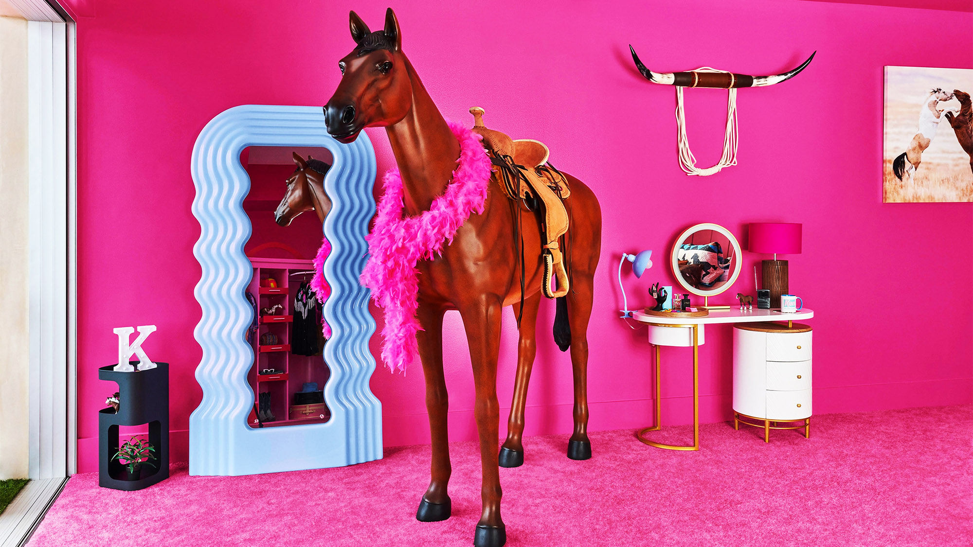Ken's bedroom at the Barbie's Malibu DreamHouse is outfitted with unique Barbie-inspired amenities, including a life-size toy horse.