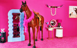 Ken's bedroom at the Barbie's Malibu DreamHouse is outfitted with unique Barbie-inspired amenities, including a life-size toy horse.