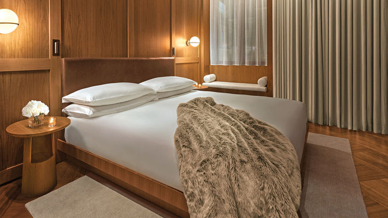 Guestrooms at the new Rome Edition are decorated with muted colors and walnut wood accents.