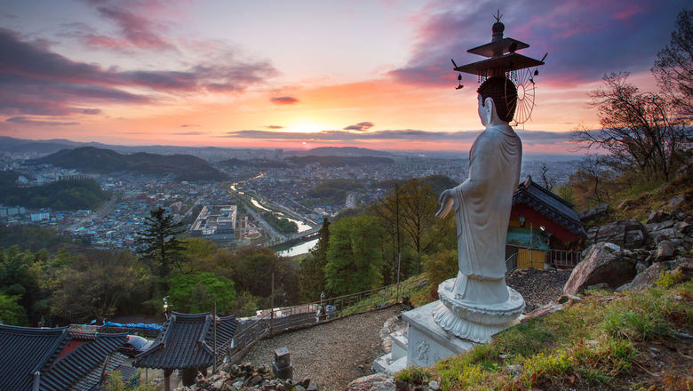 Buddhist statue towers over temple in South Korea, a new destination Contiki will offer in 2024.