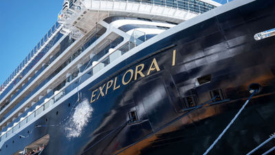 A bottle breaks on the Explora I to celebrate the ship's delivery to Explora Journeys.