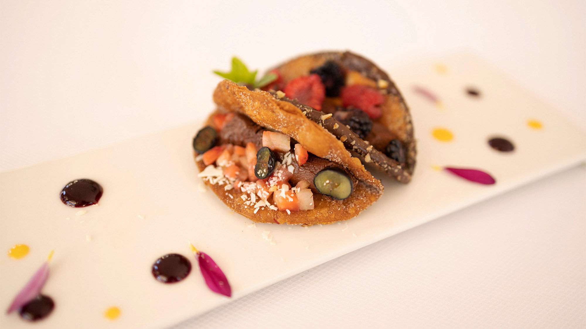The Antioxidant taco is made with buñuelo (fried dough fritter), chocolate ganache, and berries.