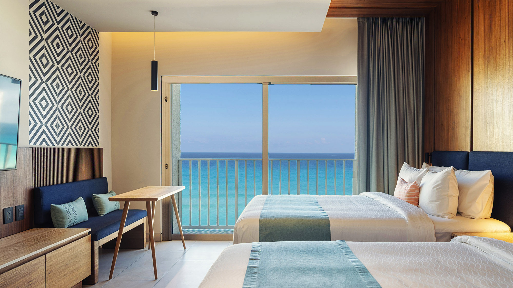 A double bed balcony beachfront guestroom at the Hilton Cancun Mar Caribe.