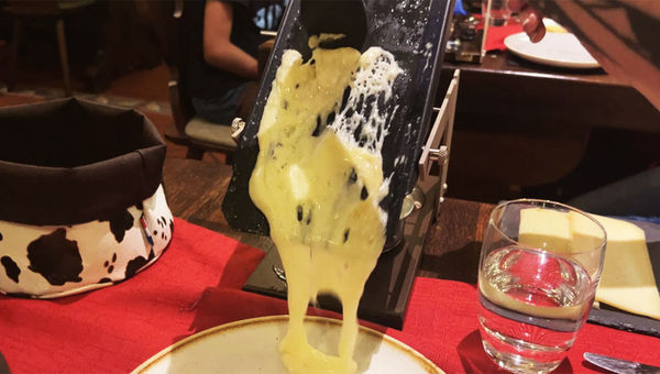 Raclette served in Zermatt. The traditional Swiss dish is melted cheese scraped off onto bread or vegetables.