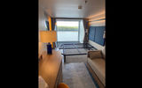 A Family Infinite Balcony Suite on Icon of the Seas. The top half of the balcony window can open and close electronically.