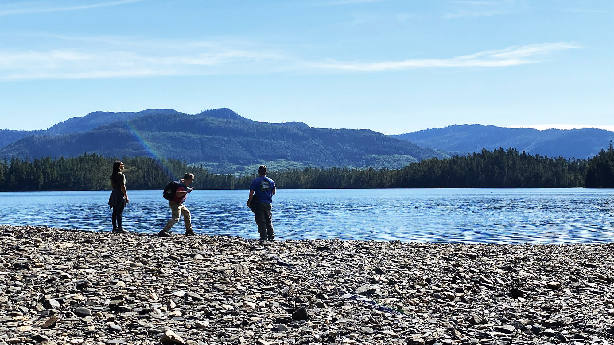 Guests on a Princess Cruises excursion skipping rocks on Mahoney Lake after a bumpy ATV ride.