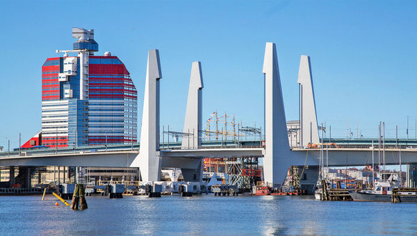 View of the Hisingsbron Bridge, distinguished by its vertical-lift span. The structure at left is known as the Lipstick building. View of the Hisingsbron Bridge, distinguished by its vertical-lift span. The structure at left is known as the Lipstick building.