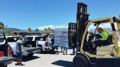 American Airlines personnel in Honolulu prepping donated water to be loaded on a Maui-bound flight.