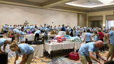 Attendees of Signature Travel Network’s Owners' Meeting sort donations to go to those affected by the Maui wildfires.