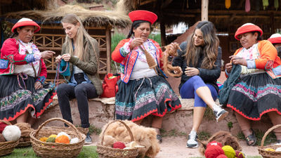 Members of the Ccaccaccollo Women’s Weaving Co-op interact with travelers in Peru's Sacred Valley.
