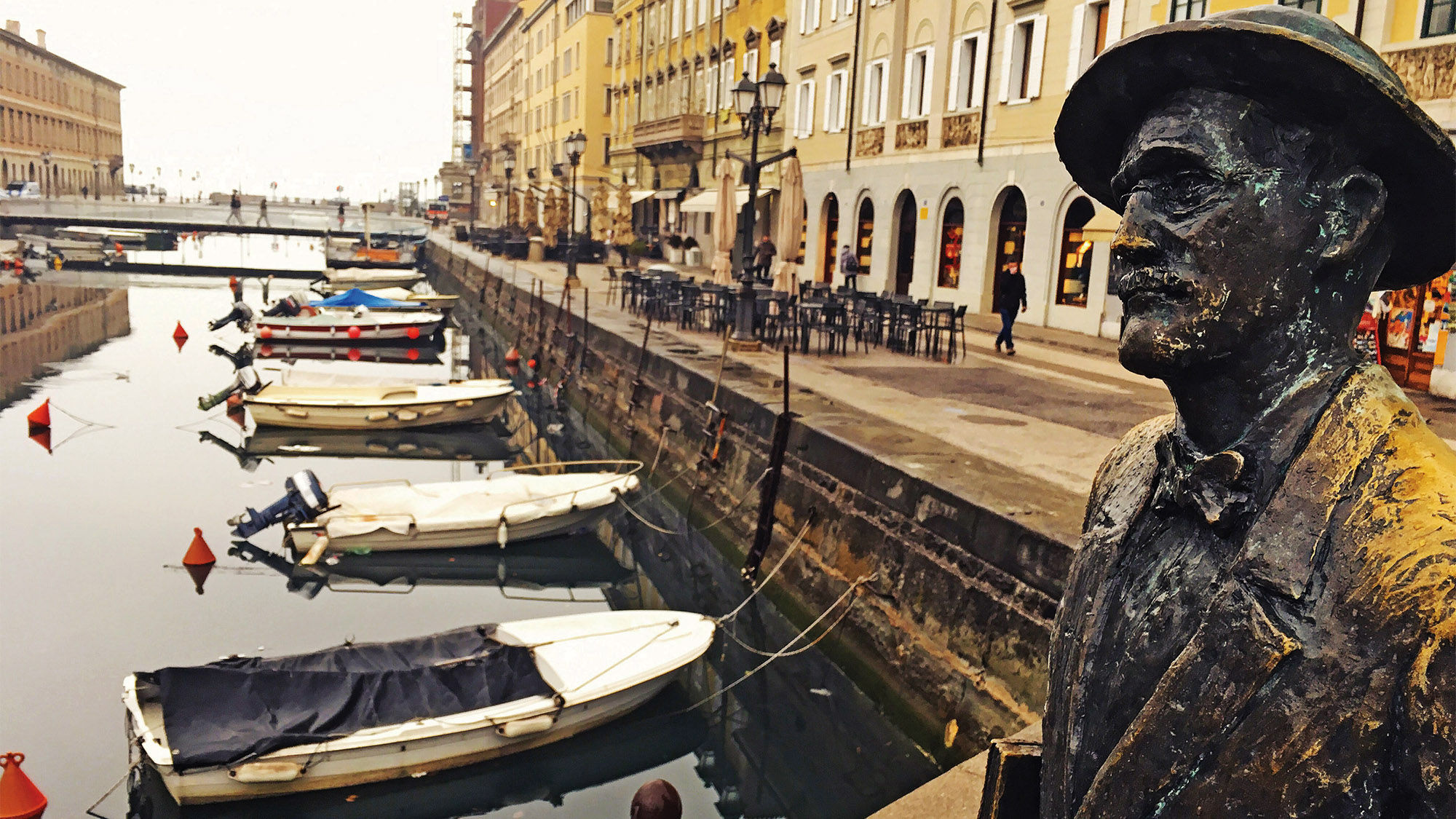 A statue of Irish author James Joyce on the Ponte Rosso bridge crossing the Grand Canal.