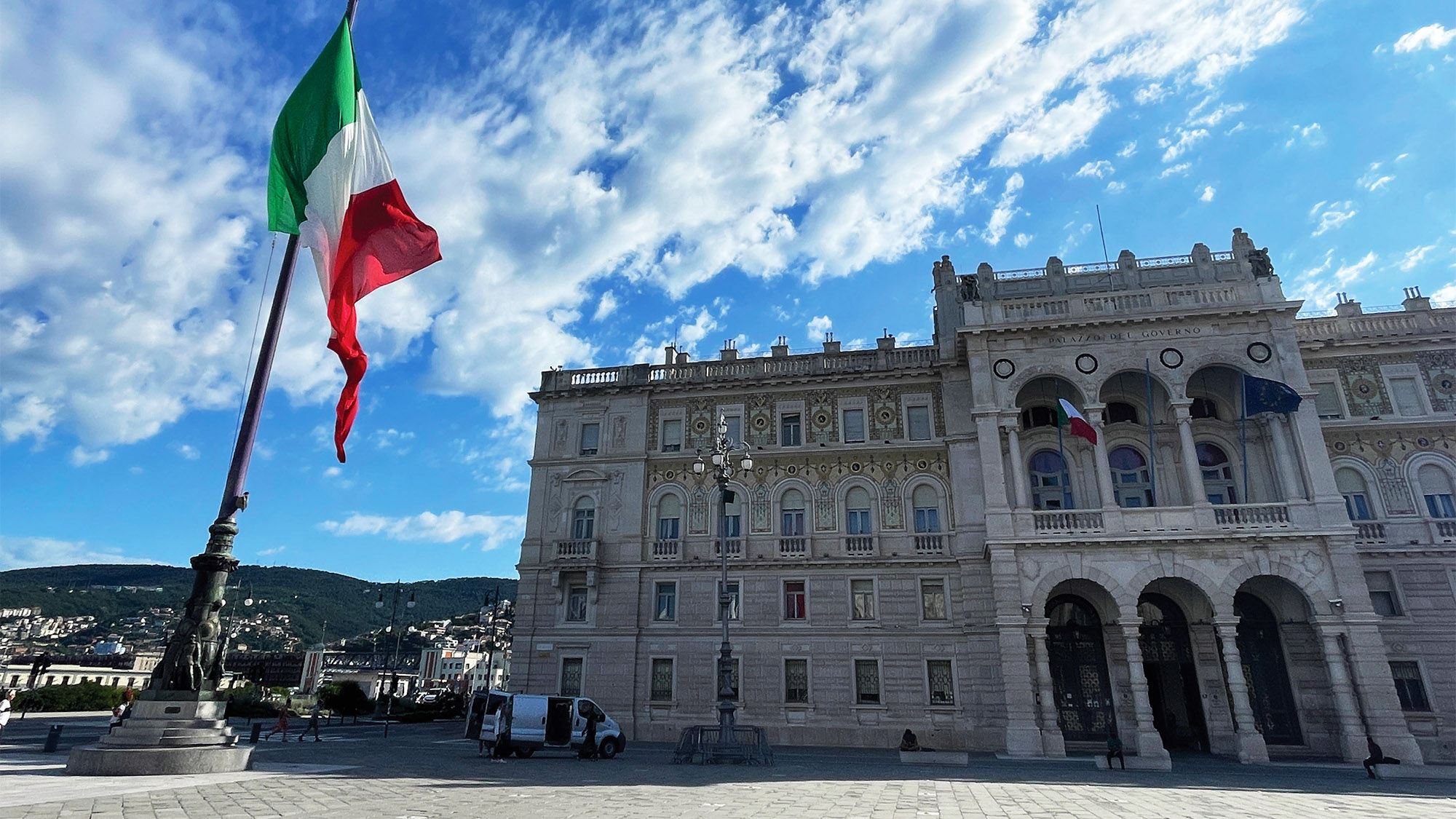 A large Italian flag waves over the governor’s palace in the Piazza Unita d’Italia, Trieste’s gathering place.