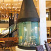 The Hythe is anchored by a warm and welcoming lobby, the centerpiece of which is a large, conical fireplace.