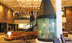 The Hythe is anchored by a warm and welcoming lobby, the centerpiece of which is a large, conical fireplace.