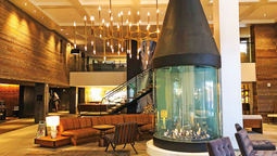 The Hythe is anchored by a warm and welcoming lobby, the centerpiece of which is a large, conical fireplace.