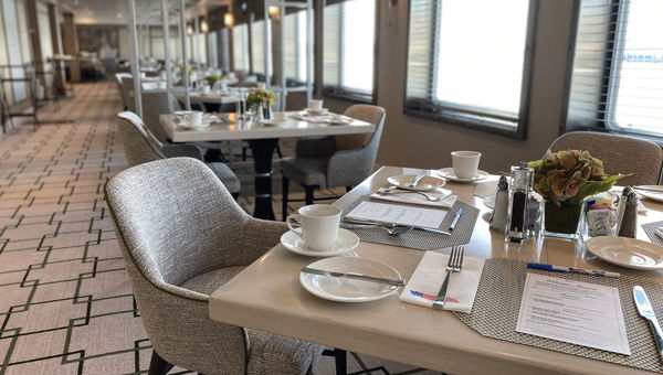 Seating in the dining room on the American Eagle is oriented in a horseshoe around the galley to provide more window seating.