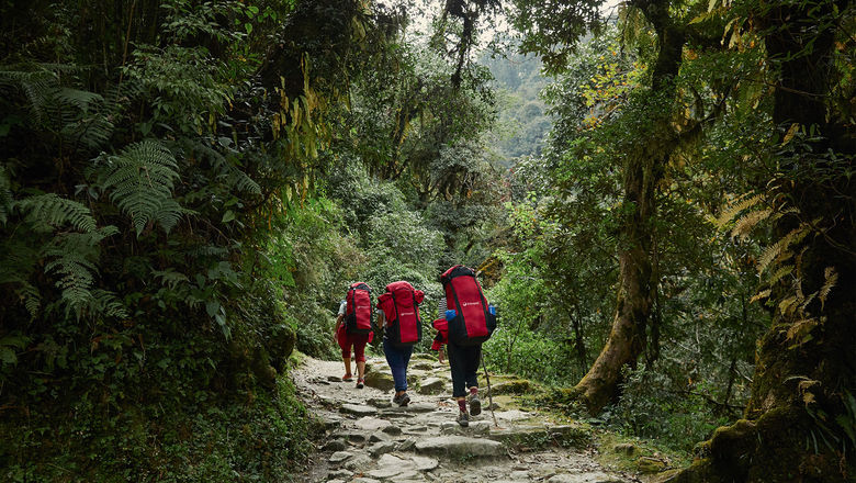 Travelers trek through Ghorepani village in Nepal with Intrepid Travel, which just began carbon labeling all of its tours on its webpage.