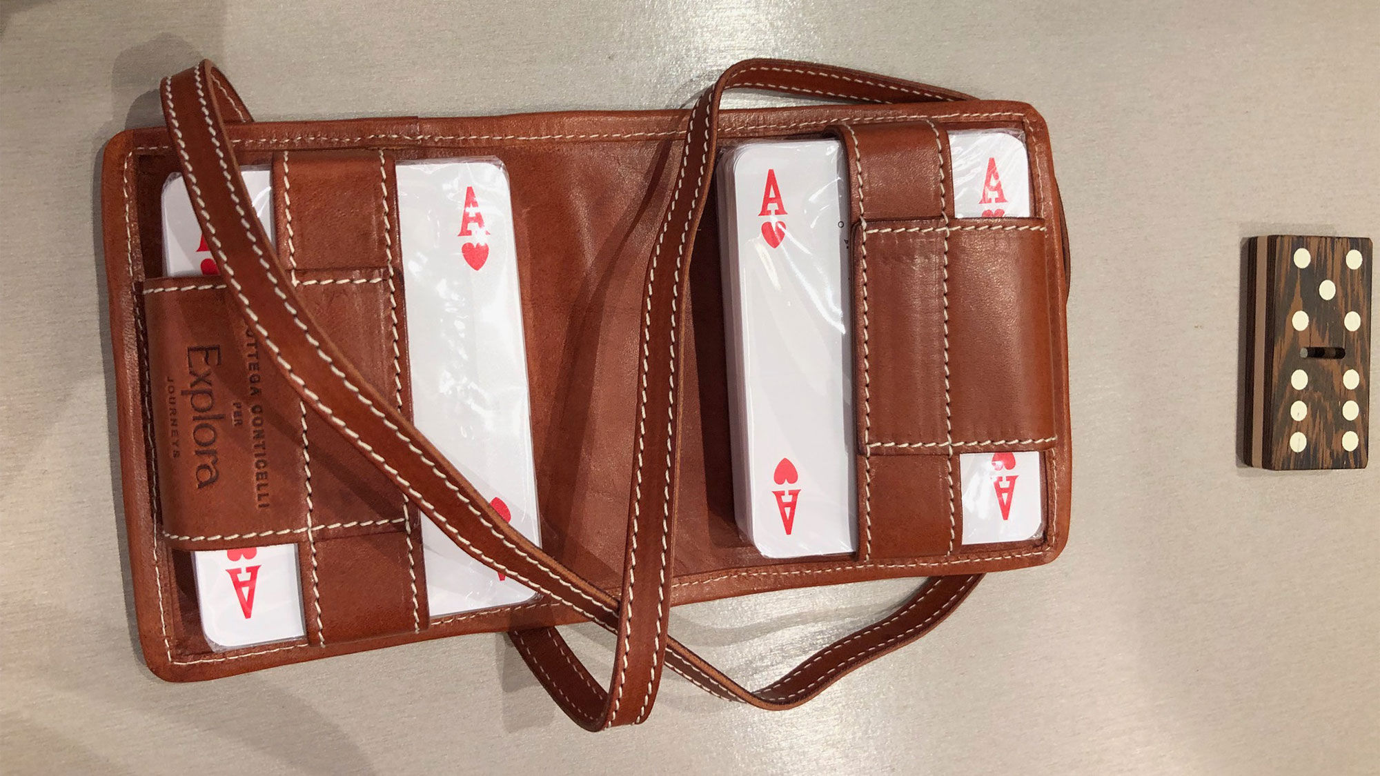 A leather carrying case for playing cards and a crafted hardwood domino were two items showcased in the "Artistry Beyond Boundaries" enrichment talk.