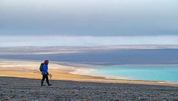 A lone hiker at a stop in Paisley Bay on the Boothia Peninsula in the Canadian Arctic. A lone hiker at a stop in Paisley Bay on the Boothia Peninsula in the Canadian Arctic.