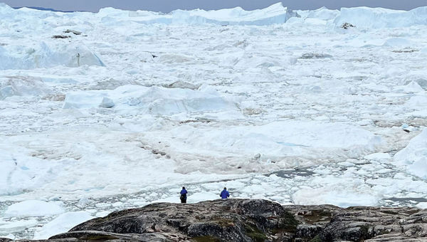Adventure Canada guests contemplate the Ilulissat Icefjord. Adventure Canada guests contemplate the Ilulissat Icefjord.