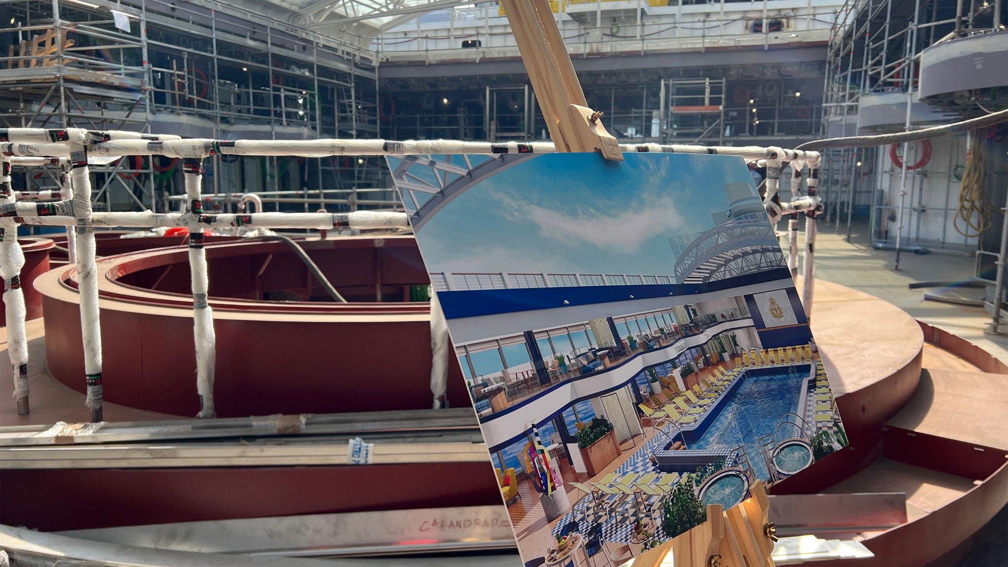 A rendering on an easel shows what the Queen Anne's midship pool area will look like. This space will include new amenities for Cunard guests, including a gelato bar and an eatery focused on healthy food.