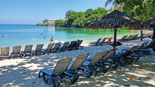 The resort's Sunset Cove beach offers guests a secluded, verdant experience. The resort's Sunset Cove beach offers guests a secluded, verdant experience.