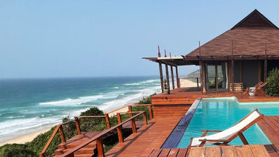 Among the amentities at the new beachfront Villa at White Pearl are an infinity pool and a bar on the pool deck.