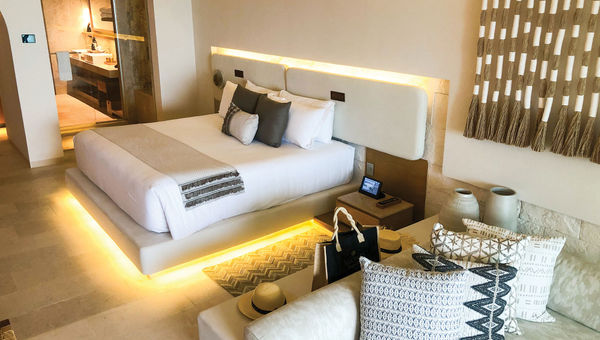 A guestroom at the Impression Isla Mujeres by Secrets, featuring an array of natural textiles and materials. A guestroom at the Impression Isla Mujeres by Secrets, featuring an array of natural textiles and materials.