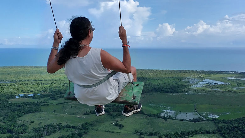 Tha author takes a ride on a swing at Montana Redonda in the Dominican Republic.