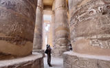 The author gazes in awe at the columns still standing at the ancient Temple of Karnak, part of the monumental city of Thebes and a UNESCO World Heritage Site.