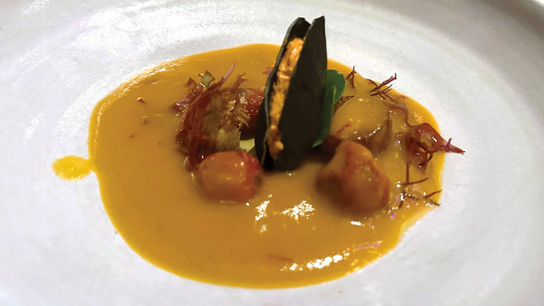 Among the dishes at Eden, a restaurant aboard the Celebrity Ascent: fennel bouillabaisse with a charcoal and piquillo pepper "mussel."