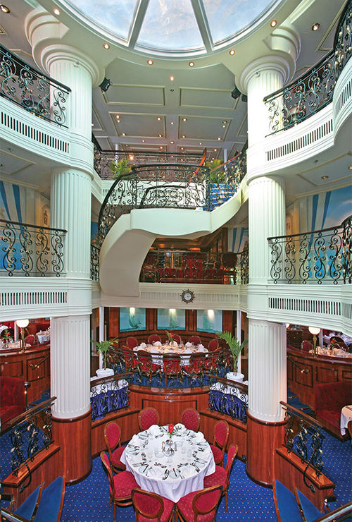 The dining room forms the base of the ship's three-story atrium. The dining room forms the base of the ship's three-story atrium.