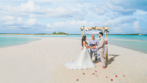 A couple getting married on a beach in Exuma, the Bahamas. A couple getting married on a beach in Exuma, the Bahamas.