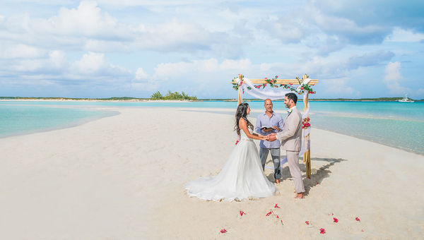A couple getting married on a beach in Exuma, the Bahamas.